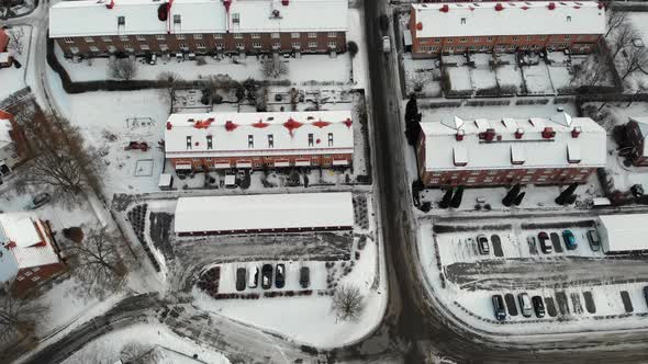 Snowy Rooftops Long Buildings in Industrial Community Aerial Top
