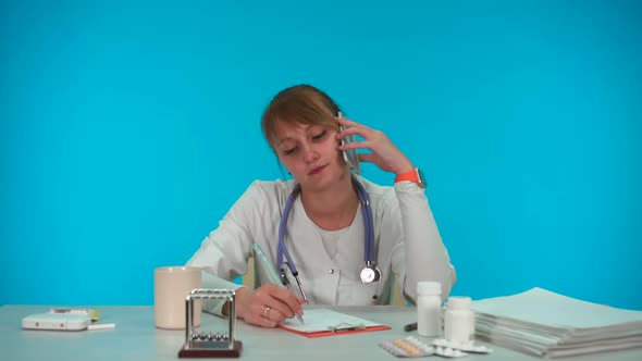 Young Doctor Novice Fills Out Paperwork, Talks on the Phone and Laughs