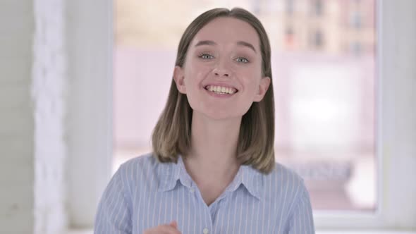 Portrait of Happy Young Woman Waving on Video Chat