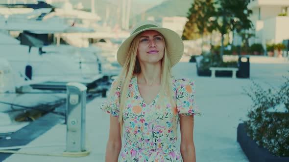 Blonde Young Woman with Blue Eyes Walking in the City Center