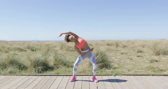 Sporty Woman Stretching on Pavement