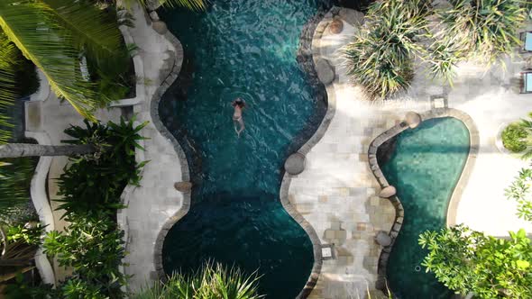 A Beautiful woman swimming in the pool