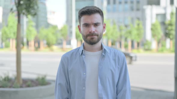 Disagree Young Man Shaking Head in Denial Outdoor