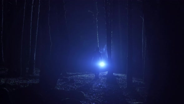 Man lost in the forest at night.