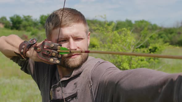 a Young Guy Shoots a Bow at a Target in Nature and Hits the Target the Arrow Pierces the Target for