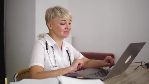 The Pleasant Adult Woman Doctor is Communicating with Patient From Home