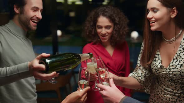 Friends Pouring Drink Glasses on Celebration Meeting in Fancy Restaurant Cafe