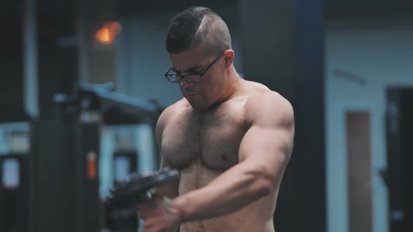 Arab Male Athlete Improves His Shoulders with Dumbbell Breeding