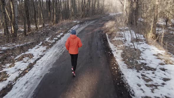 Man Running in Forest in Winter