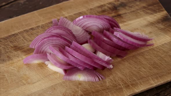 Chopped fresh onion on a wooden board close up zoom in