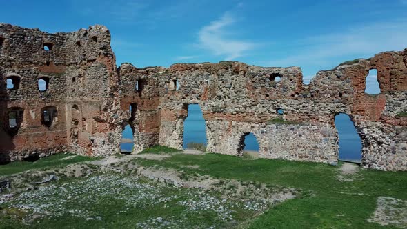 Aerial View of the Ludza Medieval Castle Ruins on a Hill  Big Ludza Lake. Camera moves forward