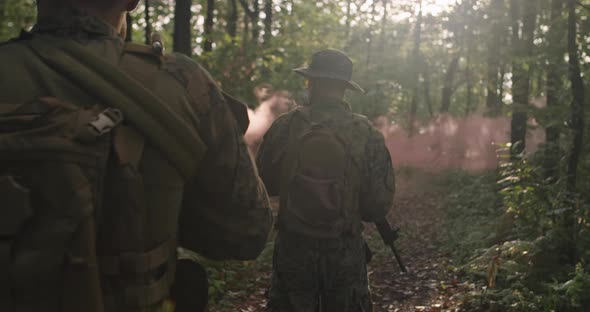 Soldiers Squad in the Smoke Moving in Battle Operation Through Dense Forest
