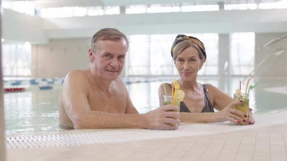 Old Spouses Enjoying Time in Indoor Swimming Pool