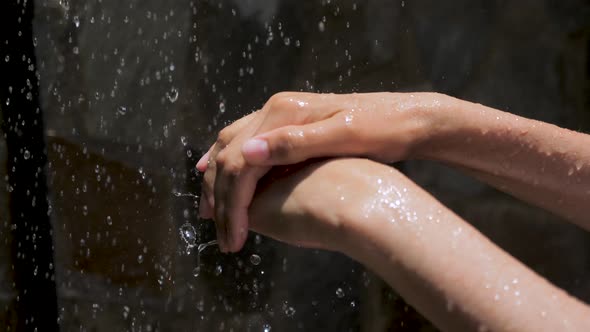 Drops of Water Drop On Women's Hands