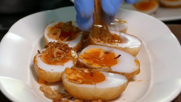 Close-up Footage of Whole Deep Fried Egg with Juicy Yolk Displaying on the White Plate