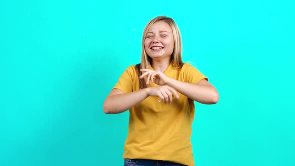 The Modest Young Woman Is Having Fun and Fooling Around Smiling