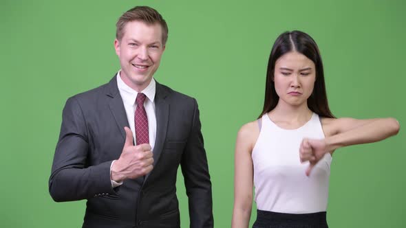 Multi-ethnic Business Couple Having Different Decisions