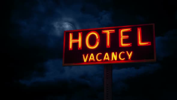 Moon In The Clouds Above Hotel Sign