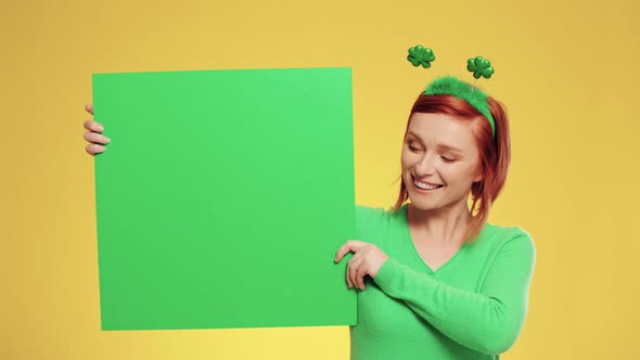 Portrait of woman holding green banner with copy space