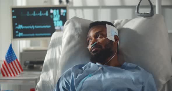 African Male Patient Lying on Medical Bed in Hospital Ward