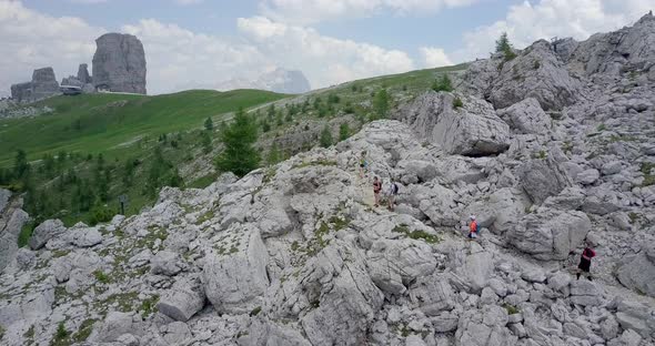 Aerial drone view of a group of people hiking in the mountains