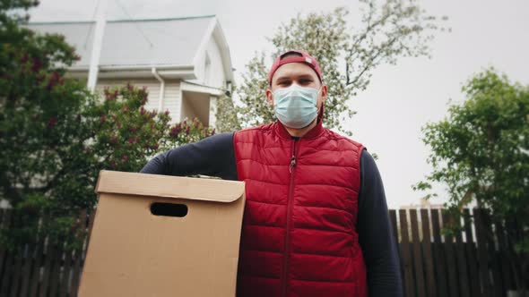 Delivery Man Holding Cardboard Boxes in Medical Gloves and Mask Coronavirus Pandemic Quarantine Home