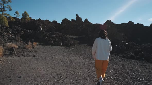Tourist Woman Walk Through the Mountains of Solidified Lava in the Teide Volcano National Park on