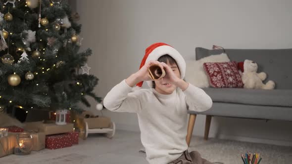 Little Boy Looking Into Spyglass From Paper