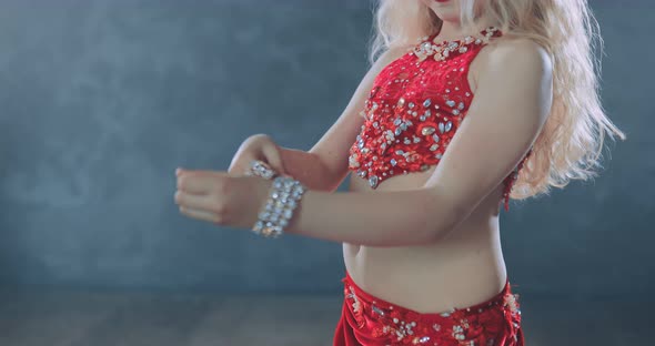 Dancer Puts Bracelets on Her Hands Stones Sparkle