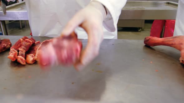 Mid section of butchers slicing red meat