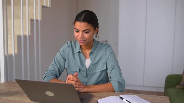 Young Positive Woman Communicating Via Video Communication Using Lapto