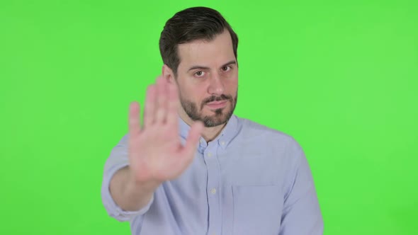 Portrait of Man Showing Stop Sign By Hand Green Screen