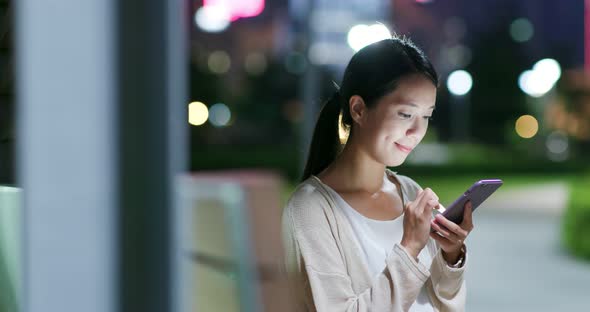 Woman use of cellphone at night