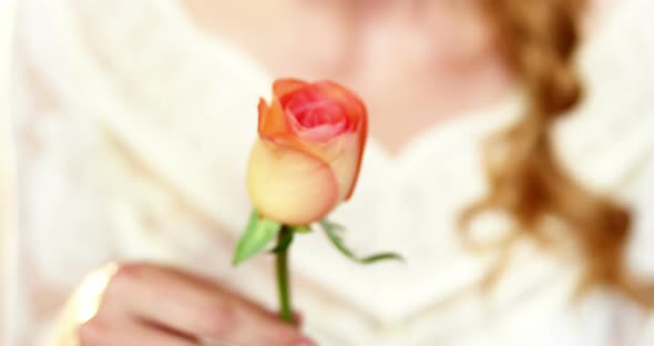 Beautiful female florist smelling rose