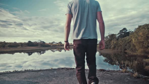 Young man walks into spectacular river view