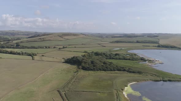 Aerial shot tracking from right to left revealing the fleet lagoon and Swannery between Chesil beach