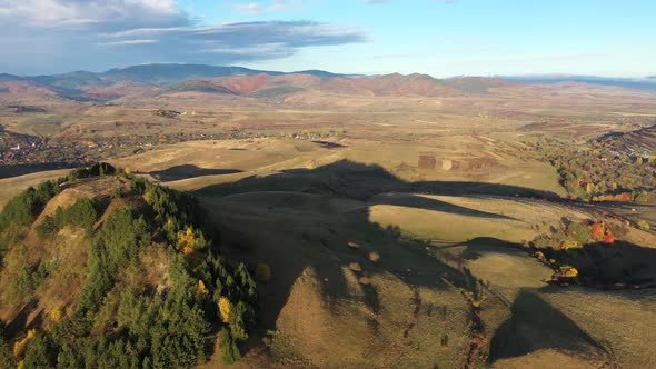 Aerial Autumn Countryside Landscape. Vibrant Hills in Morning Lights