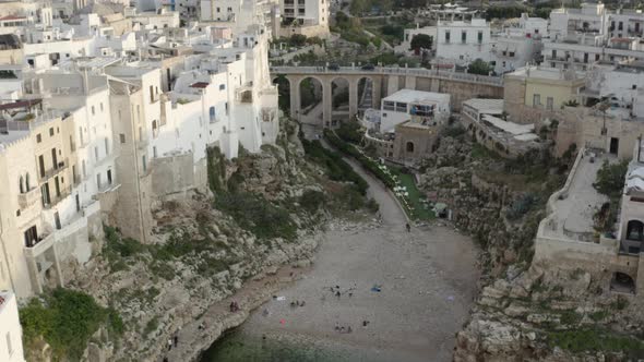 Forward aerial view of the beach and the city behind. Polignano a Mare. Italy