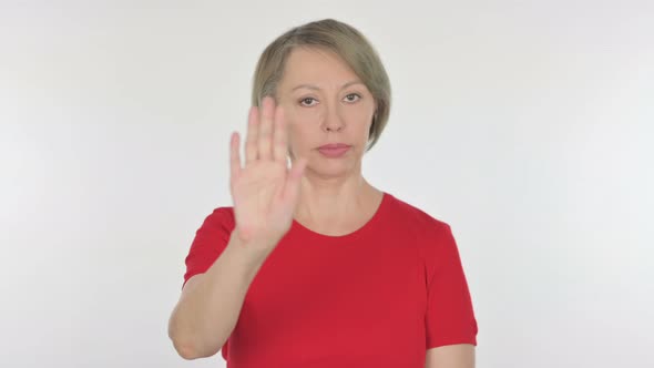 Stop Gesture By Old Woman in Denial on White Background