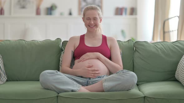 Beautiful Pregnant Woman Smiling at Camera