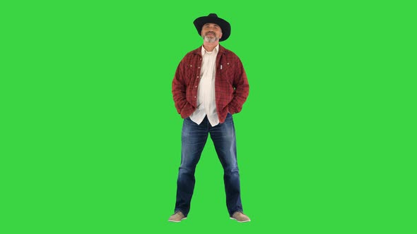 Elderly Caucasian Man Farmer Agronomist in Cowboy Hat Smiling To Camera on a Green Screen Chroma Key