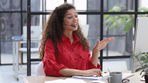 Call Operator in Red Shirt Wears Headset Customer Service Manager Looking to Webcam Communicating in