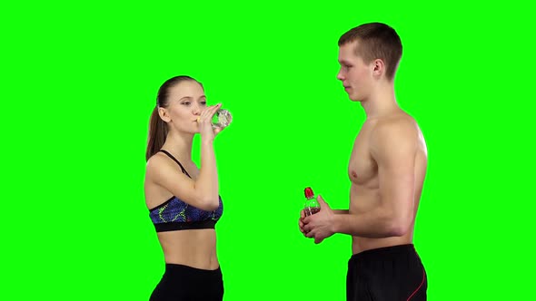 Couple with Water Bottles. Green Screen