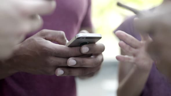 African American Man Typing Message on Smartphone