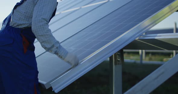 Men Installing Solar Panel Outdoors