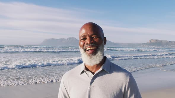 Senior african american man smiling at the beach