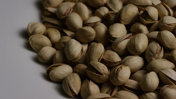 Cinematic, rotating shot of pistachios on a white surface - PISTACHIOS 036