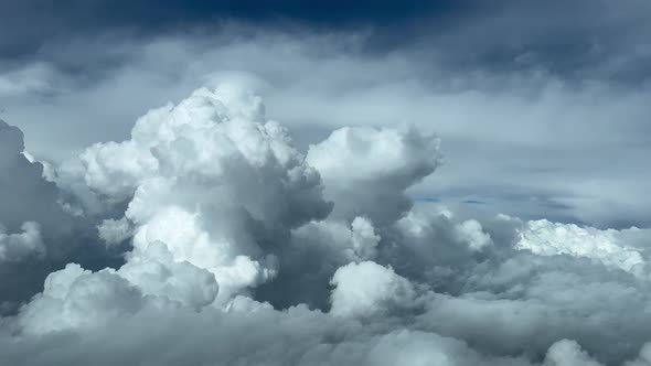 Aerial view, pilot POV of a stormy sky plenty of cumulus and cumulonimbus during cruise levet al 350