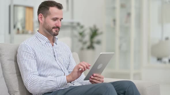 Professional Young Man Using Tablet at Home