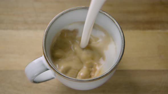 WIDE SHOT, creamy frothy oat milk finishes a cappuccino, 60fps